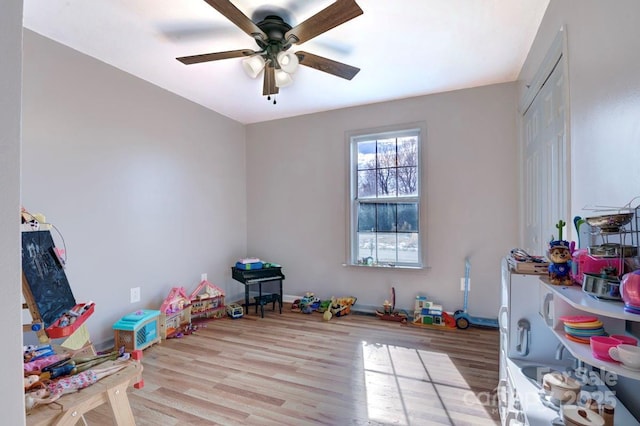 recreation room with ceiling fan and light wood-type flooring