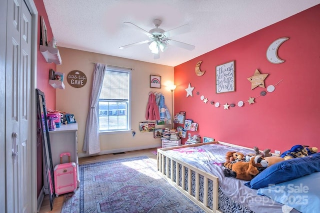 bedroom with ceiling fan, a closet, and a textured ceiling