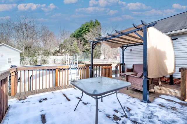 snow covered deck with a pergola