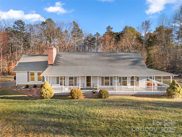 back of house featuring a yard and covered porch