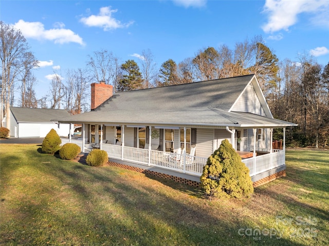 rear view of property with a yard and covered porch