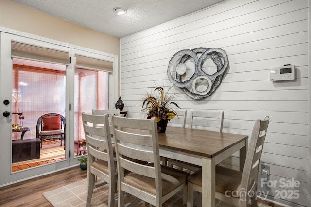 dining area featuring hardwood / wood-style floors and a textured ceiling