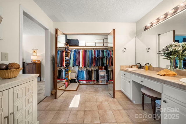 bathroom with vanity and a textured ceiling