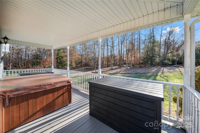 wooden terrace with a hot tub