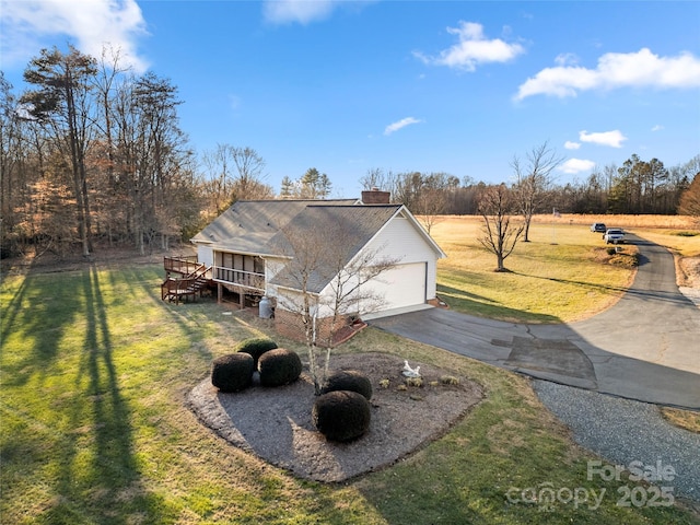 view of front of house with a garage and a front lawn