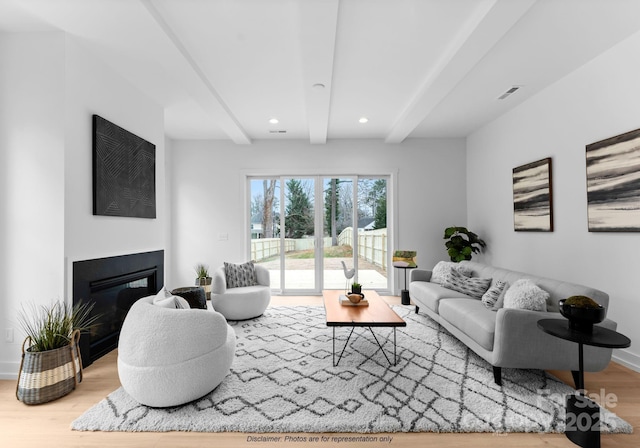 living room featuring beam ceiling and hardwood / wood-style flooring