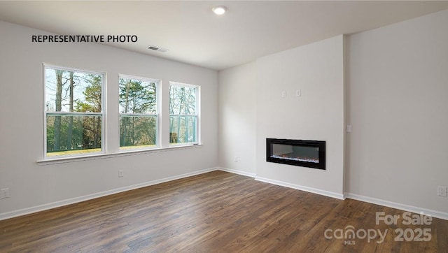 unfurnished living room with dark hardwood / wood-style floors