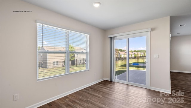 spare room featuring dark hardwood / wood-style flooring