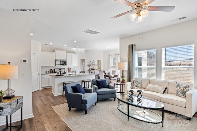 living room featuring hardwood / wood-style flooring and ceiling fan