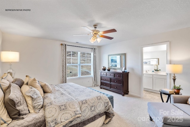 carpeted bedroom with a textured ceiling, ceiling fan, and ensuite bathroom