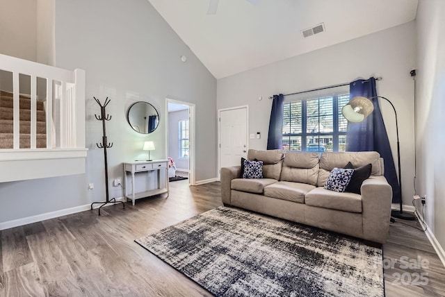 living room featuring hardwood / wood-style flooring and high vaulted ceiling