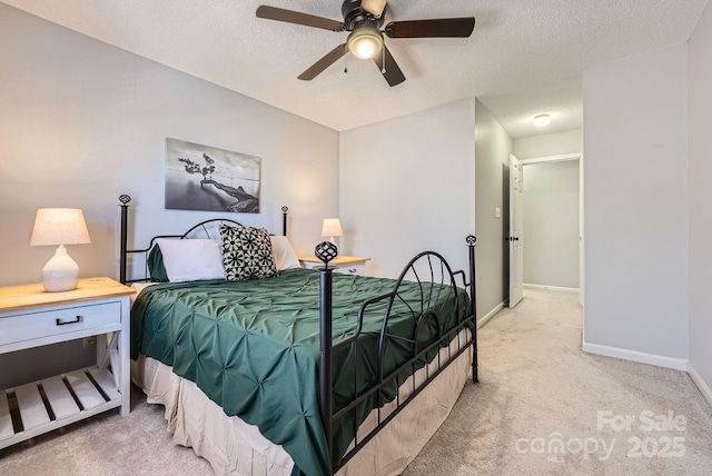 carpeted bedroom with ceiling fan and a textured ceiling