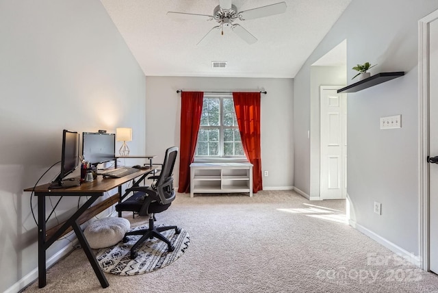 carpeted home office with ceiling fan, lofted ceiling, and a textured ceiling