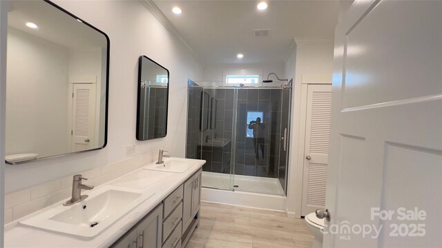 507 E Lackey Farm Rd, Stony Point, NC 28678 - bathroom with double vanity, a stall shower, a closet, ornamental molding, and toilet