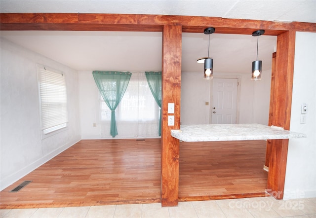 kitchen with pendant lighting and light hardwood / wood-style flooring