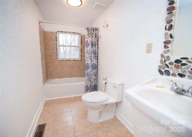 full bathroom featuring sink, tile patterned floors, toilet, and shower / tub combo