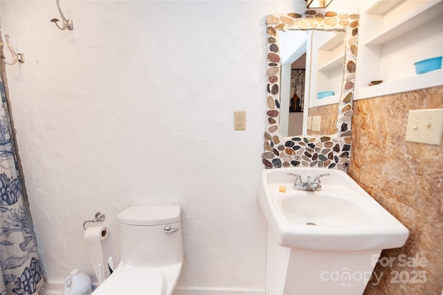 bathroom featuring decorative backsplash, built in features, and toilet