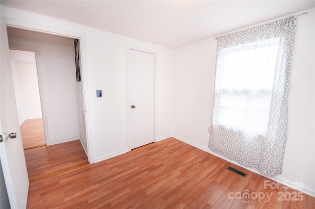 unfurnished bedroom with hardwood / wood-style flooring