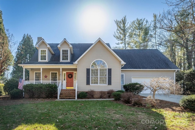 view of front of home featuring a porch, a garage, and a front yard