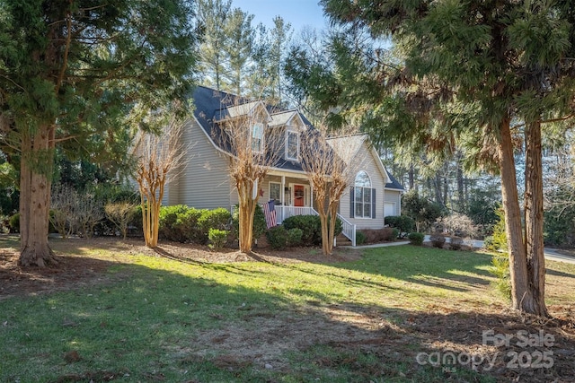 new england style home featuring a porch and a front lawn