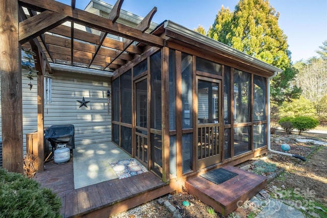 exterior space with a sunroom and grilling area