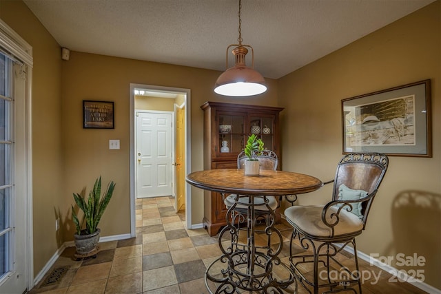 dining space with a textured ceiling