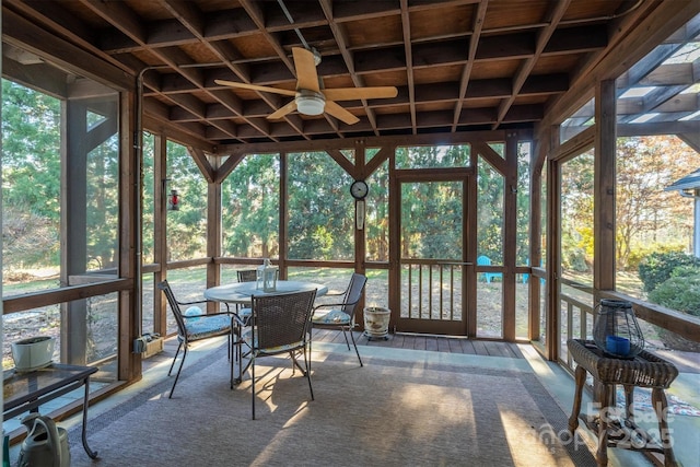 unfurnished sunroom with ceiling fan