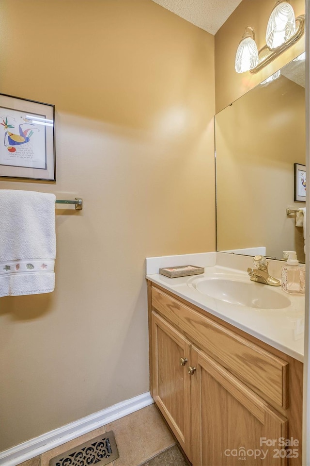 bathroom featuring tile patterned floors, vanity, and a textured ceiling