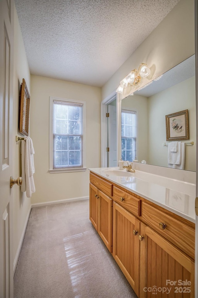 bathroom featuring vanity, a wealth of natural light, and a textured ceiling