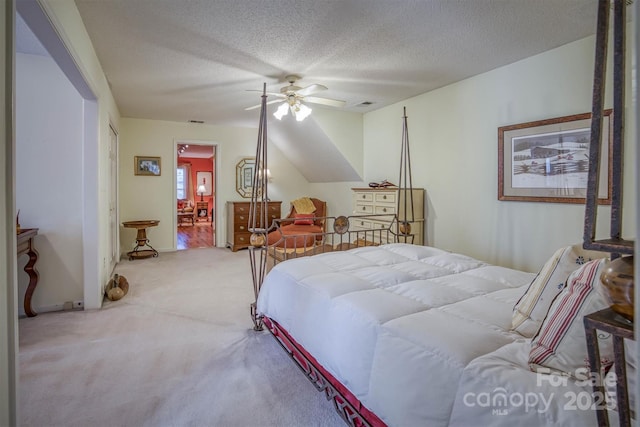 carpeted bedroom featuring ceiling fan and a textured ceiling