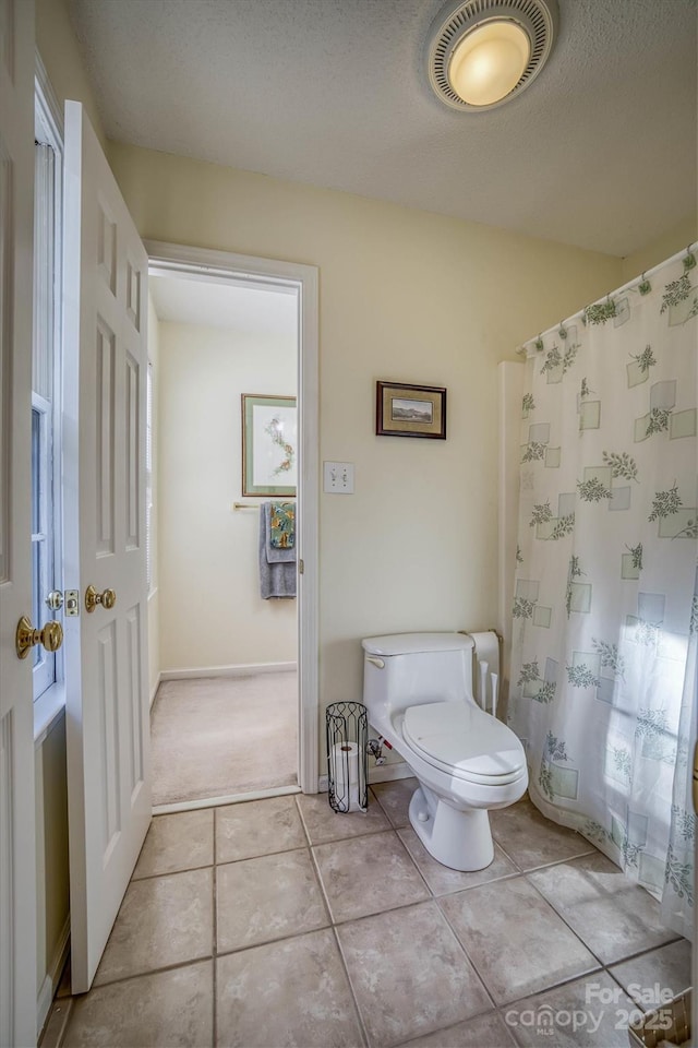 bathroom featuring tile patterned floors and toilet