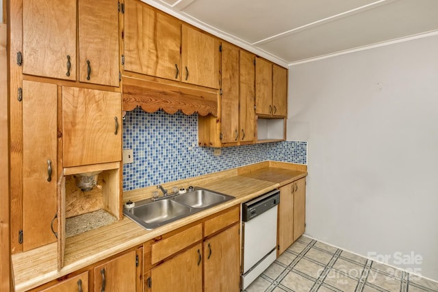 kitchen with a sink, white dishwasher, light countertops, crown molding, and backsplash