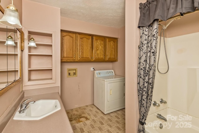clothes washing area with a textured ceiling, laundry area, a sink, and washer / dryer