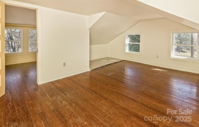 bonus room featuring lofted ceiling, wood finished floors, and baseboards