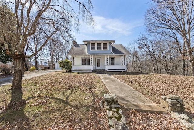 bungalow-style home with covered porch and a chimney