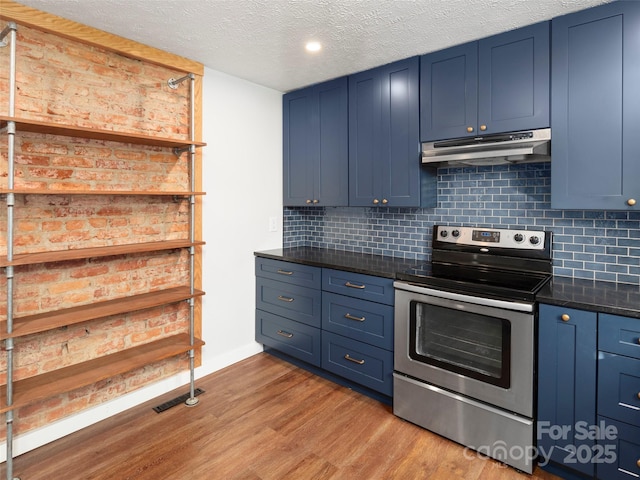 kitchen featuring blue cabinetry, decorative backsplash, stainless steel electric range oven, and light hardwood / wood-style flooring