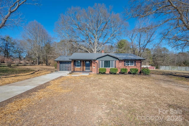 ranch-style home with a garage and a front yard