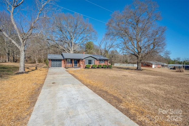 ranch-style home featuring a garage and a front yard