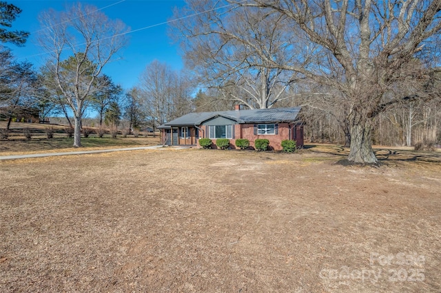 ranch-style house featuring a porch and a front yard