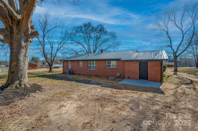 rear view of property featuring central AC unit and a patio area