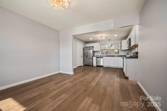 kitchen with white cabinetry, sink, dark hardwood / wood-style flooring, and stainless steel appliances