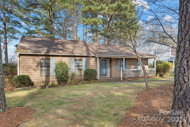 ranch-style home with covered porch and a front lawn