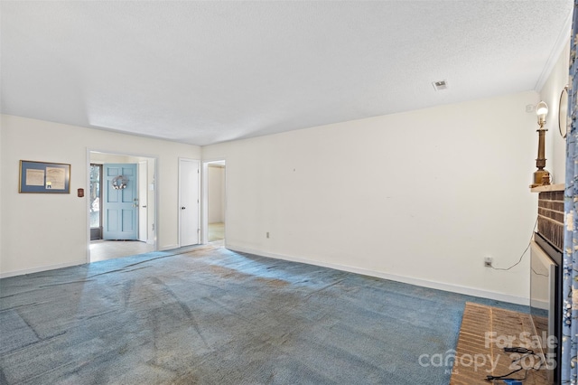 unfurnished living room featuring carpet floors, a brick fireplace, a textured ceiling, and baseboards