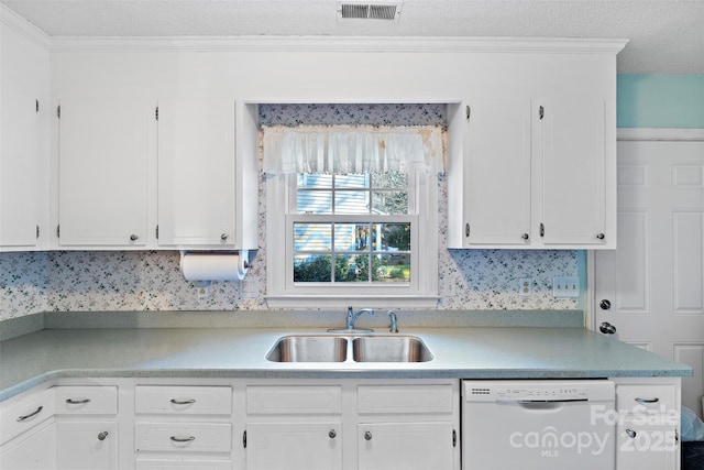 kitchen with light countertops, visible vents, white cabinets, a sink, and dishwasher