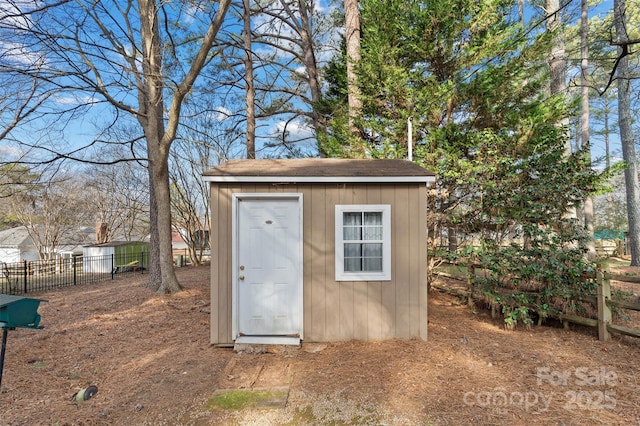 view of shed featuring fence