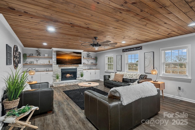 living room featuring a stone fireplace, dark hardwood / wood-style flooring, ceiling fan, wood ceiling, and crown molding