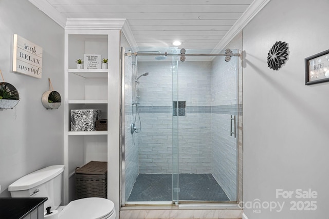 bathroom featuring crown molding, toilet, an enclosed shower, and built in shelves