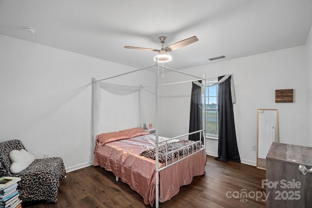 bedroom with ceiling fan and dark hardwood / wood-style floors