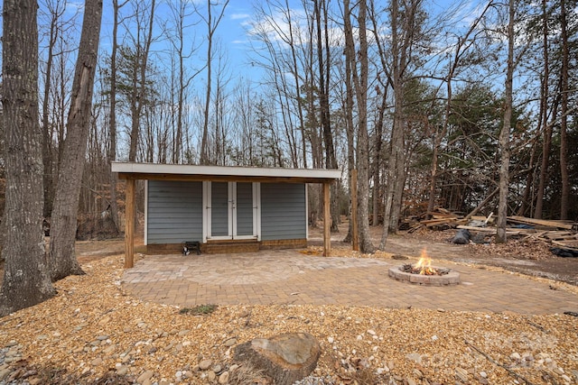 view of outdoor structure featuring a fire pit