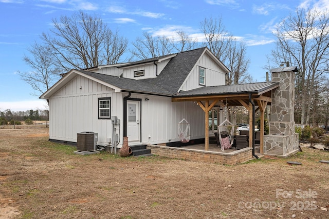 rear view of property featuring a lawn, a patio area, and central air condition unit